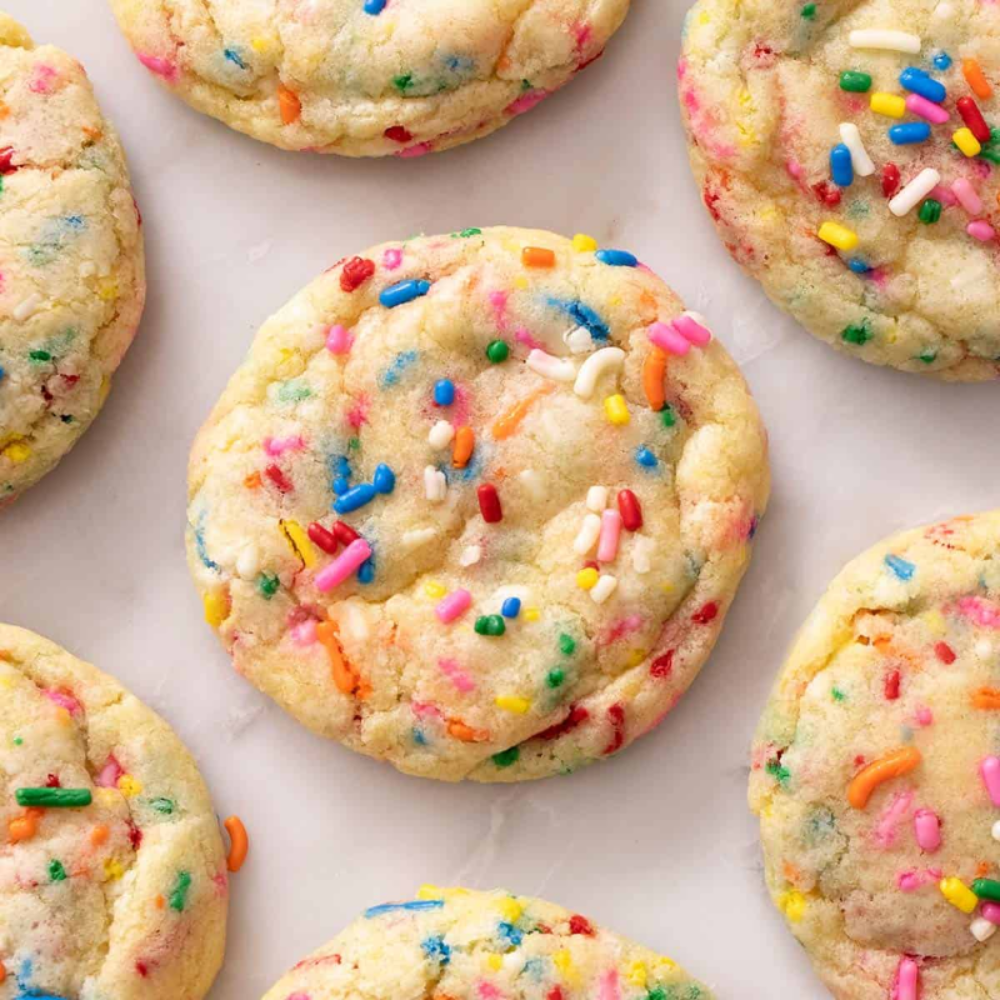 Cookies with colorful sprinkles on a marble surface